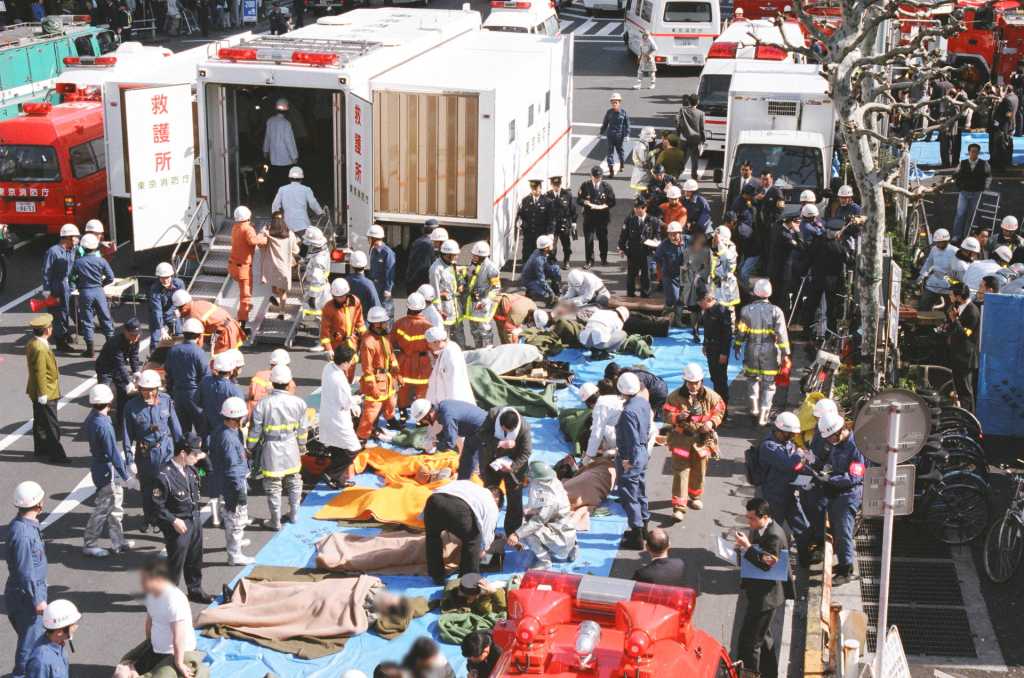 Ambulanser, hjelpemannskap og skadde på gata etter sarinangrepet på T-banen i Tokyo i 1995.