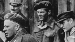 Sort-hvitt bilde av Leif Tronstad sammen med kong Haakon VII og kronprins Olav. 