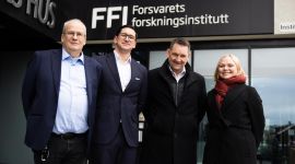 Gruppebilde av Arild Bergh (FFI), Peter Vinje-Banfield, Geir Holmefjord og Silje Lensu Dåbakk (FFI) foran inngangspartiet til FFI. 
