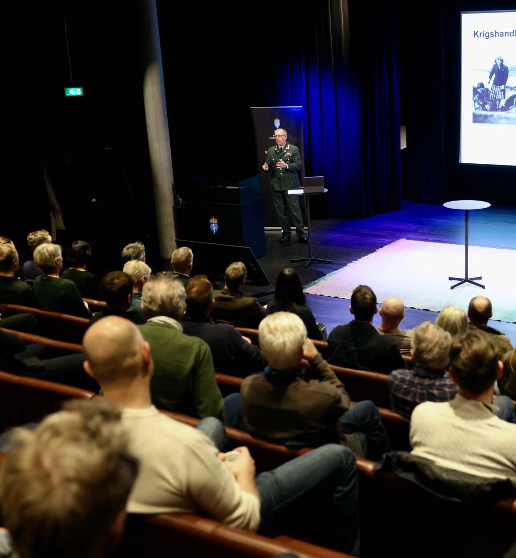 Oversiktsbilde fra Deicmansalen. Fotografen står bak publikum og fotograferer Geir P. Novik og hans persentasjon.