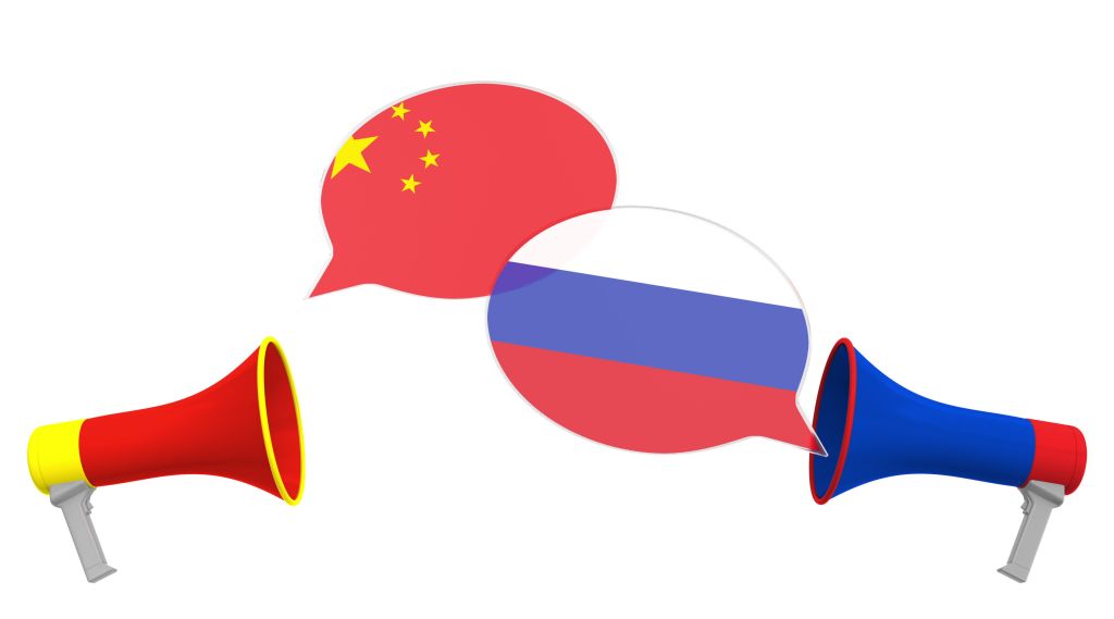 Flags of Russia and China on speech bubbles with loudspeakers. Intercultural dialogue or international talks related 3D rendering
