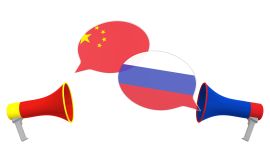 Flags of Russia and China on speech bubbles with loudspeakers. Intercultural dialogue or international talks related 3D rendering