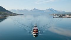 Ship in Tromsö, Norway, with panorama view to mountains in the background