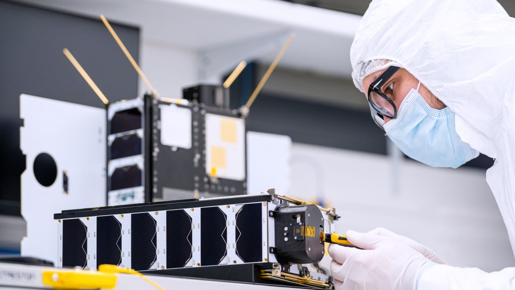 Man working on the satellites in the clean room at NanoAvionic