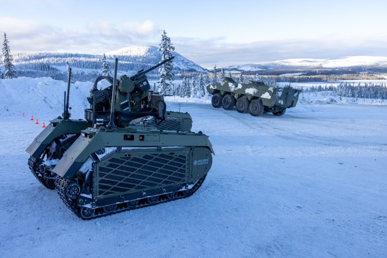 Two UGVs on a snow covered norwegian mountain.