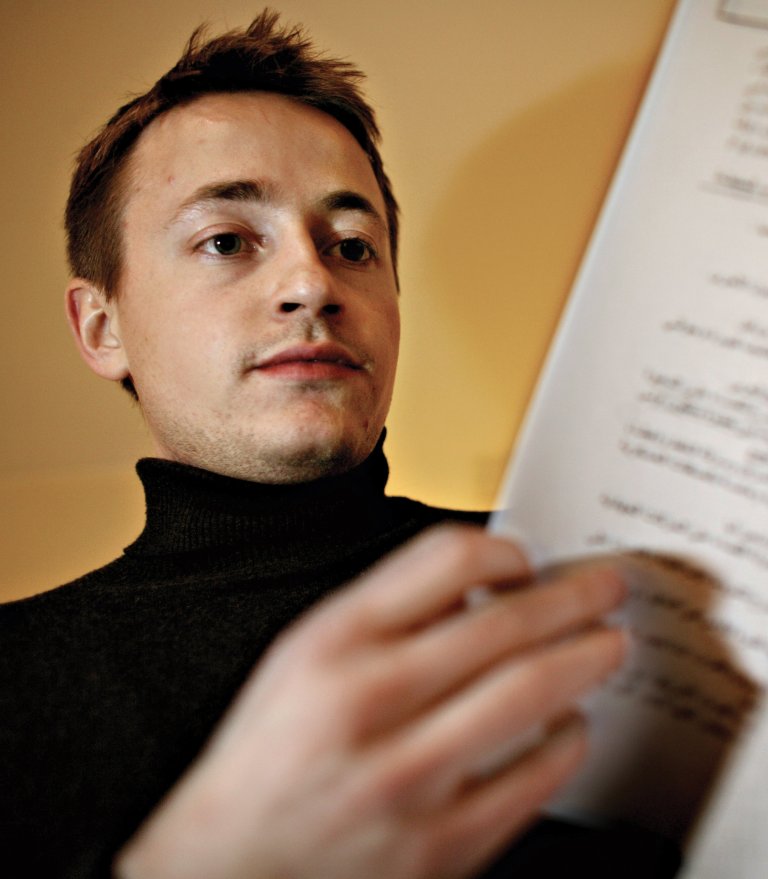 Male researccher holding paper