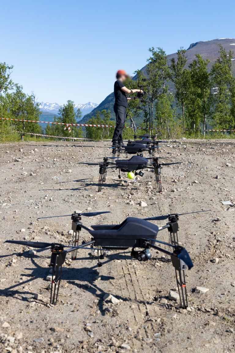 Researcher preparing a surveillance drone. Outside. Mountains. Summer.