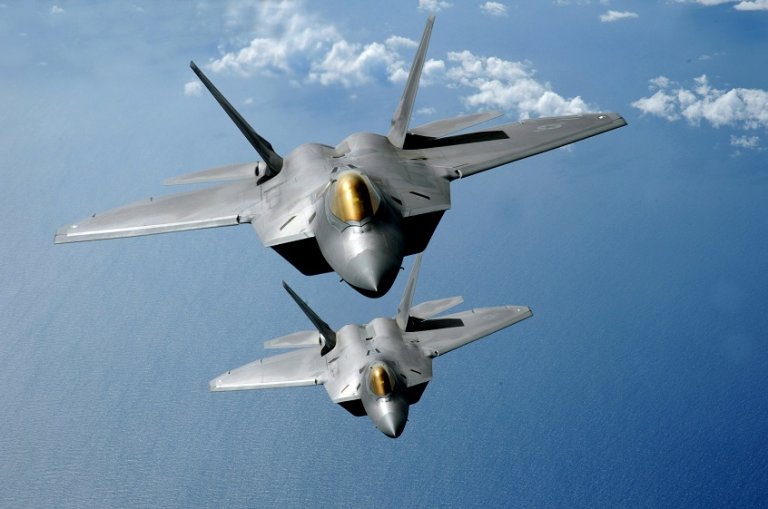 F22 Raptors fly over the Pacific Ocean